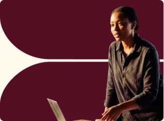 A colleague seated with a laptop