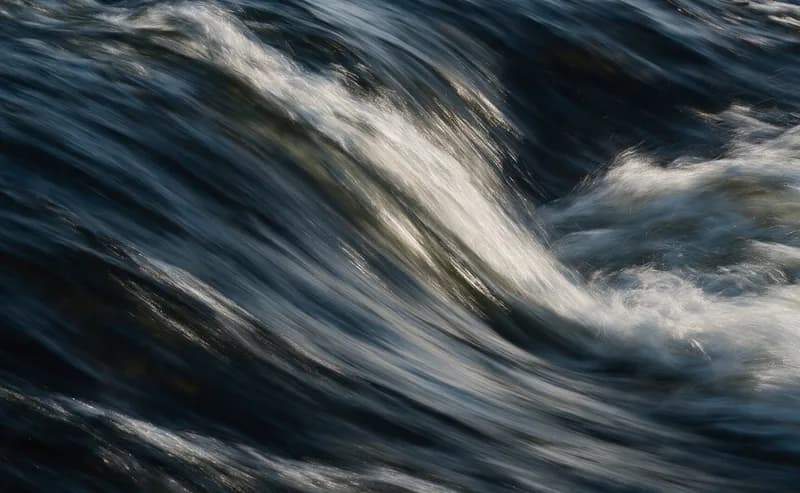 Fast-moving water breaking into white spray