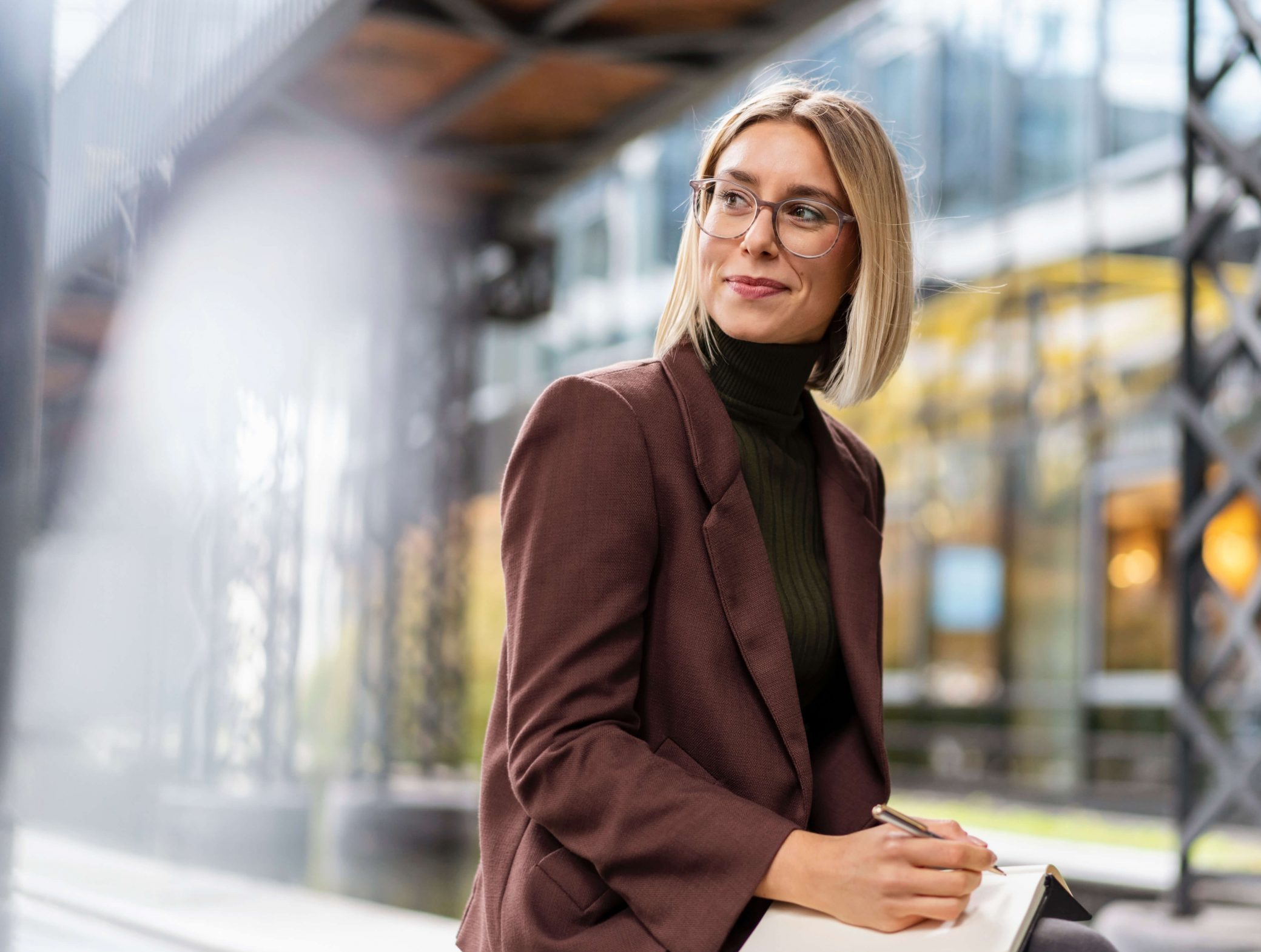 smiling-young-businesswoman-with-notebook-in-the-c-2022-11-06-23-04-07-utc