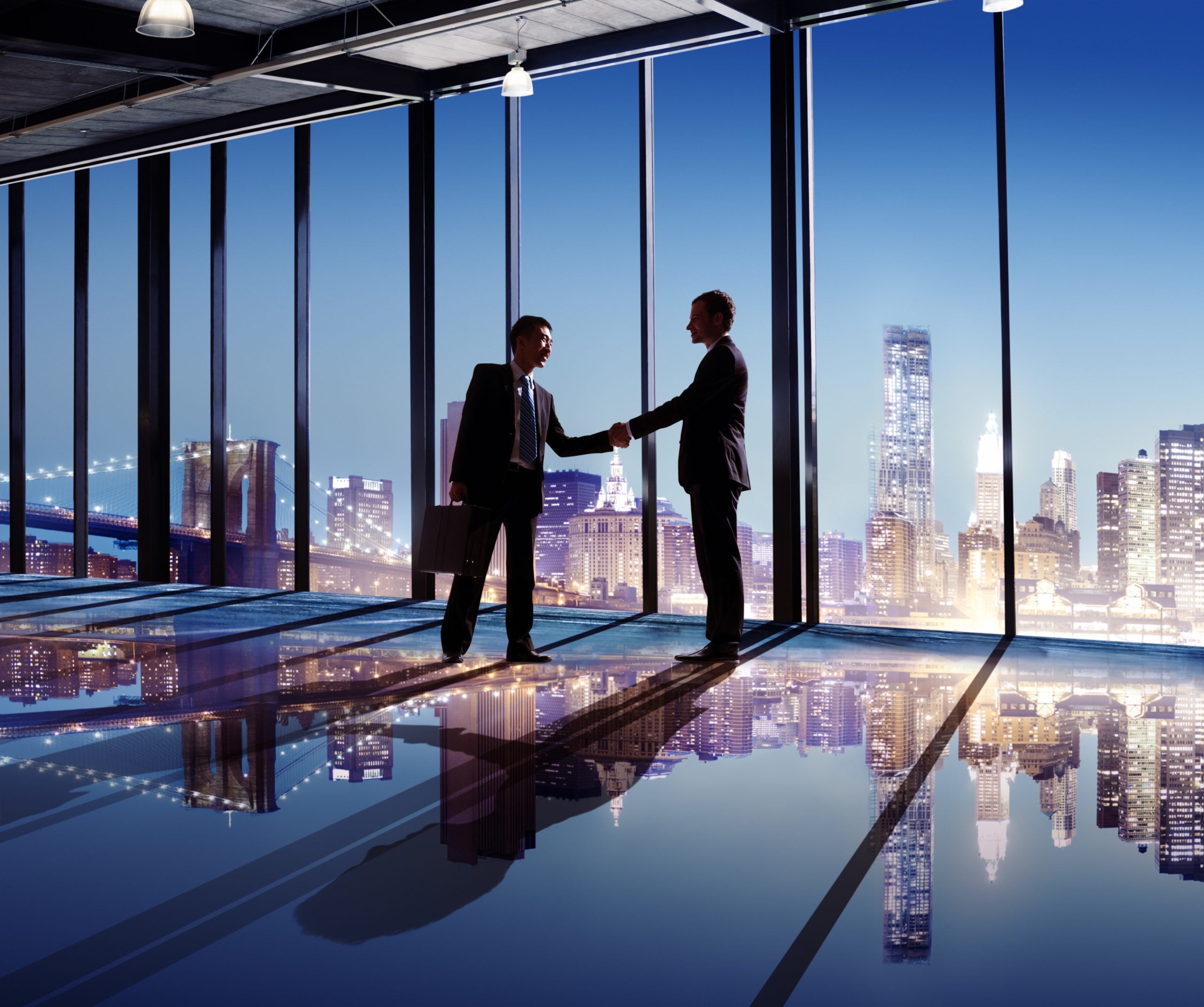Businessmen,Shaking,Hands,With,City,View